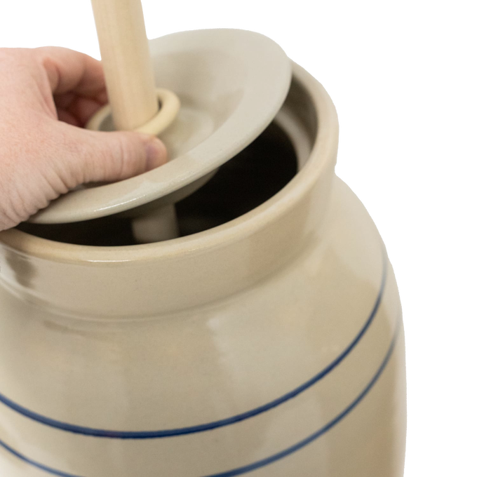 Handcrafted stoneware churn in natural stone color with smooth unfinished wooden dasher, featuring traditional double blue stripes, made in USA, part of Kitchen & Food and Specialty Equipment collections.