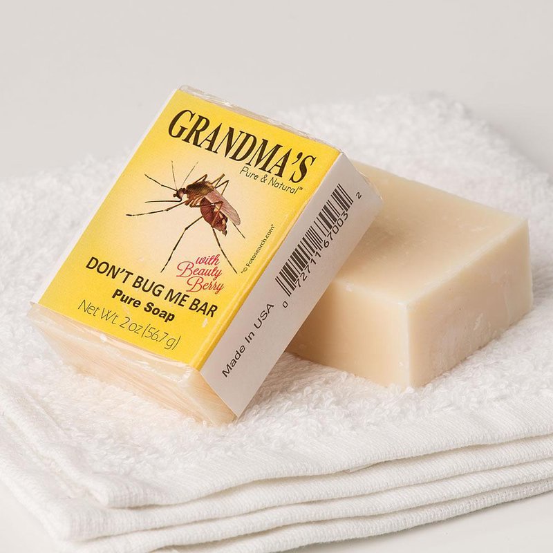 Natural handmade bar soap labeled for repelling mosquitoes, featuring essential oils and beauty berry, resting on folded white towels, made in USA and part of Health & Wellness collections.