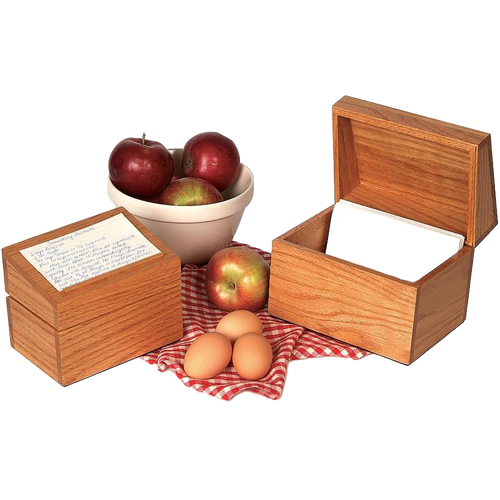 Handcrafted solid oak recipe box with smooth protective finish and recessed hinges, accompanied by apples in a bowl, fresh apples, and eggs on a red checkered cloth, ideal for Kitchen & Food, Cookware, Baking Supplies, Holiday Hosting, Kitchen Gadgets, Kitchen Accessories, Storage and Serving, USA Made, Best Sellers, and Promo Eligible collections.