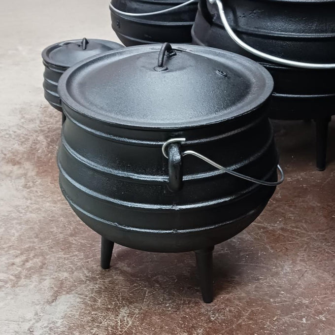 Handcrafted cast iron campfire kettle with distinctive round shape, three sturdy legs, and wire bail handle, designed for durable outdoor cooking in Farm, Garden & Tool, Camping, Best Sellers, Promo Eligible collections.