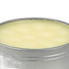 Open round metal tin filled with smooth pale yellow beeswax blend for seasoning and conditioning cast iron and carbon steel cookware, USA made kitchen essential