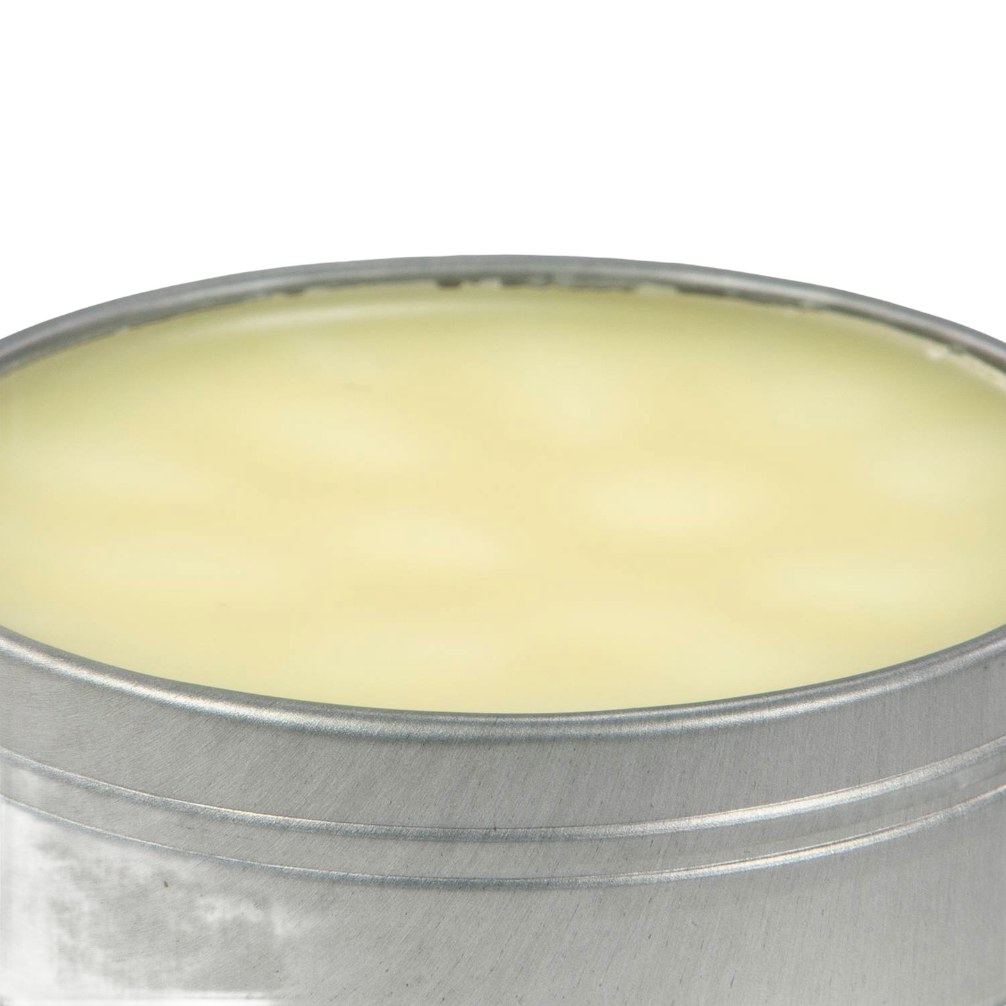 Open round metal tin filled with smooth pale yellow beeswax blend for seasoning and conditioning cast iron and carbon steel cookware, USA made kitchen essential