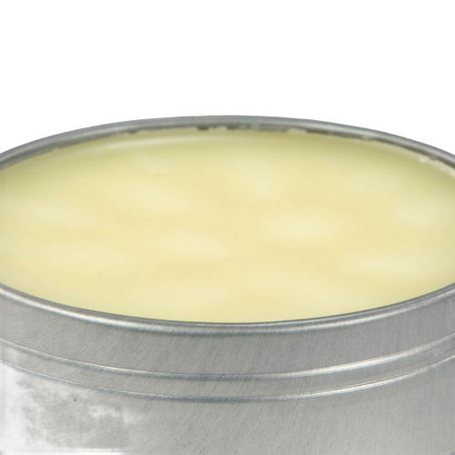 Open round metal tin filled with smooth pale yellow beeswax blend for seasoning and conditioning cast iron and carbon steel cookware, USA made kitchen essential
