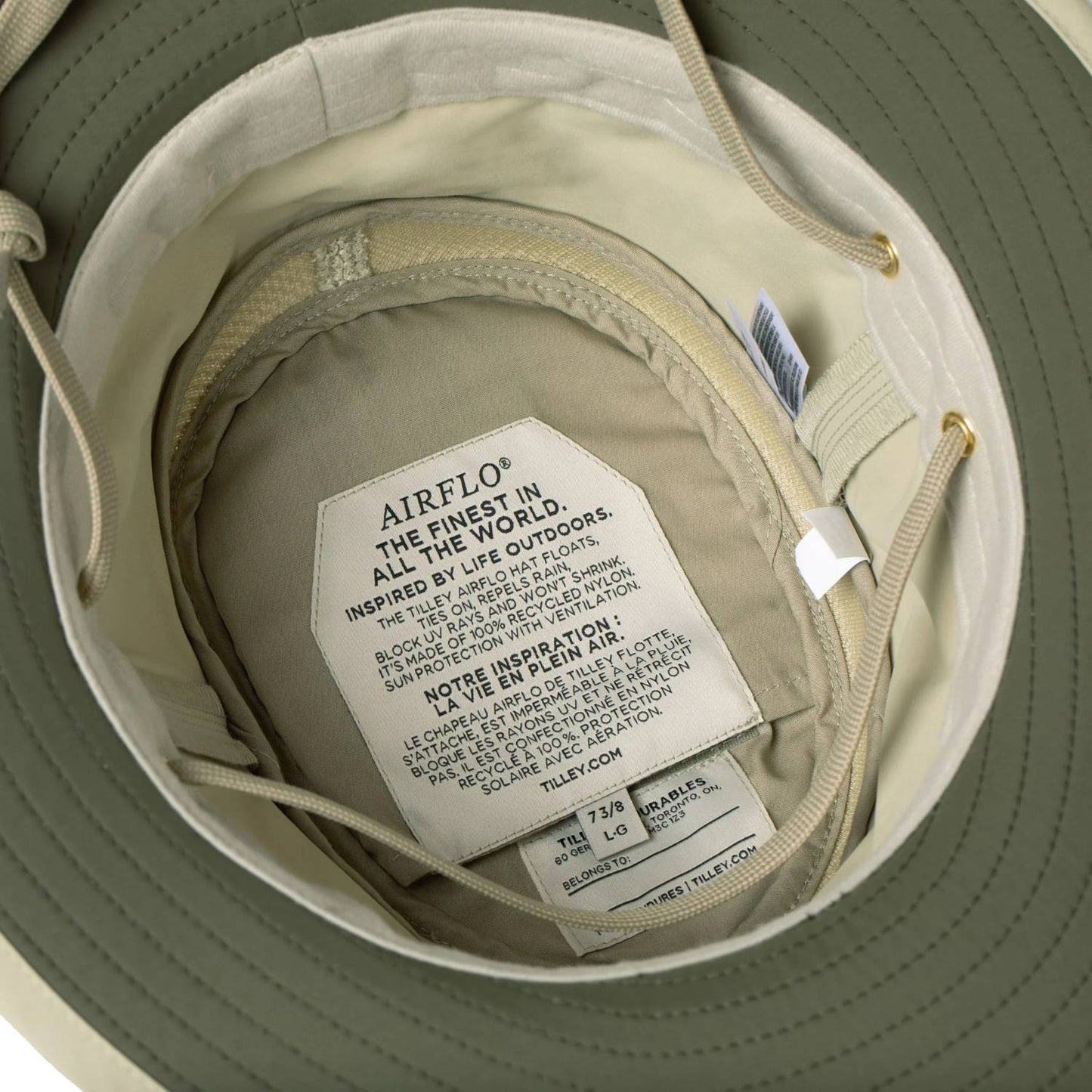 Close-up inside view of a khaki medium-brim hat featuring an AirFlo label highlighting sun protection and breathable mesh technology, ideal for outdoor, gardening, camping, and wellness activities.