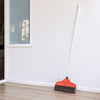Handcrafted electrostatic broom with a polyurethane foam brush and red plastic housing leaning against a white wall on a wood floor, ideal for Home & Decor and Household Cleaning collections.