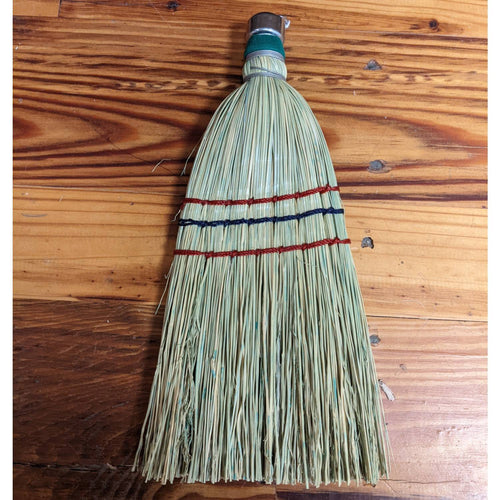 Handcrafted corn straw whisk broom with colorful stitching and metal band, made in USA, ideal for efficient household cleaning and included in Best Sellers and Amish Made collections.