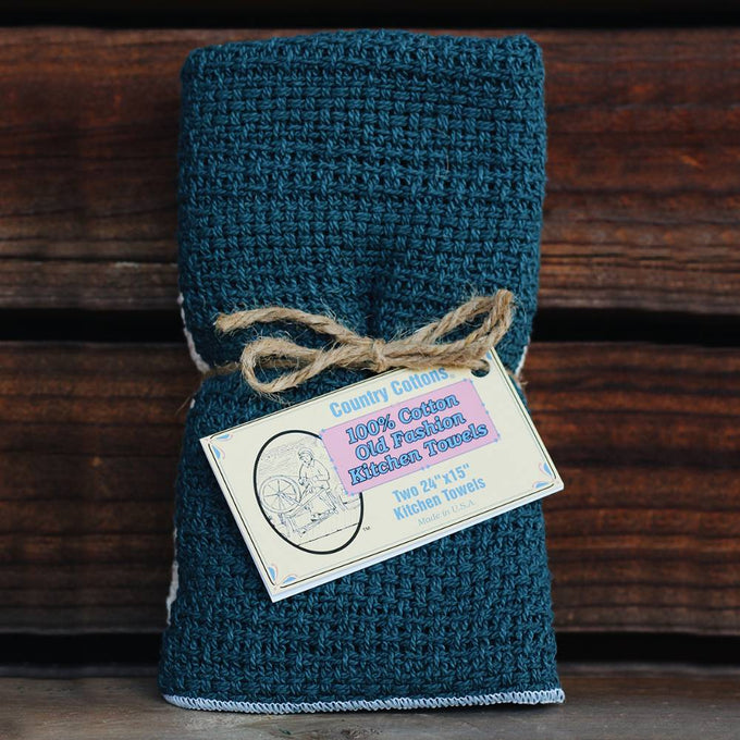 Set of two loosely woven kitchen towels in deep blue cotton, with a rustic twine tie and vintage-style label, featured in Kitchen & Food, Kitchen Textiles, USA Made, Best Sellers, and Promo Eligible collections.