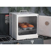 Aluminized steel portable oven with built-in thermometer, folding design for camping, shown baking muffins on a single burner stove, ideal for Farm, Garden & Tool and Camping collections.