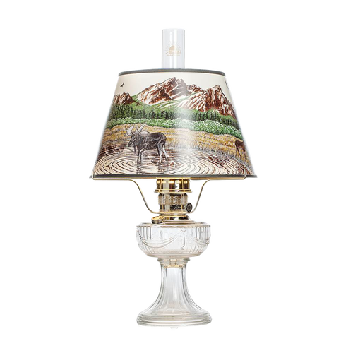 Clear glass oil lamp with brass burner and scenic Rocky Mountain parchment shade featuring wildlife and mountain landscape, perfect for Lamps & Lighting, Oil Lamps, Table Lamps, Best Sellers, and Promo Eligible collections.