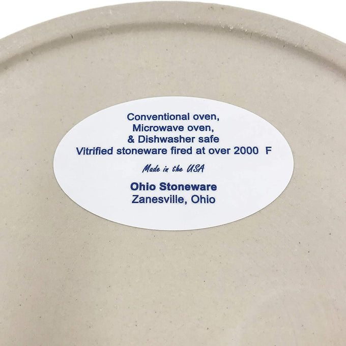 Close-up of a cream-colored stoneware crock label indicating it is safe for conventional oven, microwave, and dishwasher use, made in the USA, featured in Kitchen & Food, Food Preservation, and Best Sellers collections.