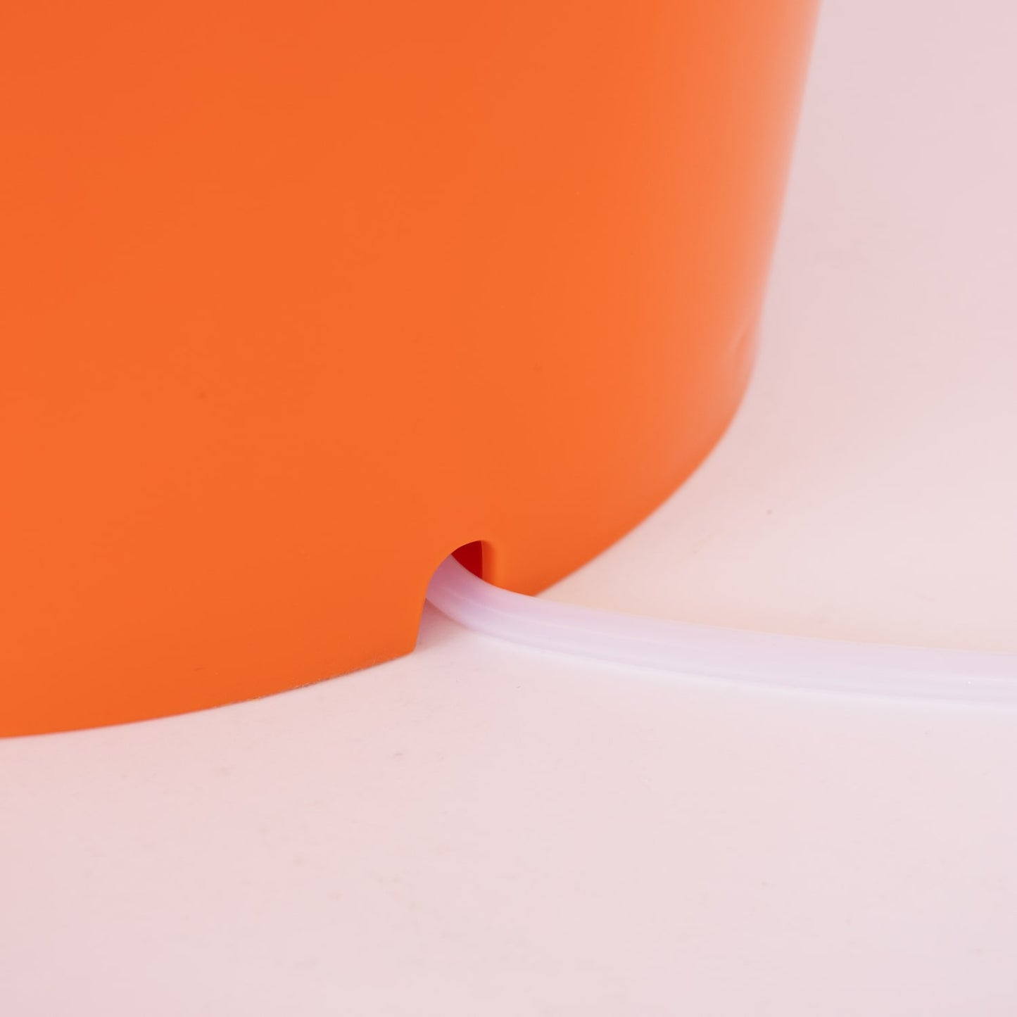 Close-up of orange handcrafted laundry spinner’s drainage spout with clear plastic tube, designed for efficient water removal in Home & Decor, Laundry Supplies, and Best Sellers collections.