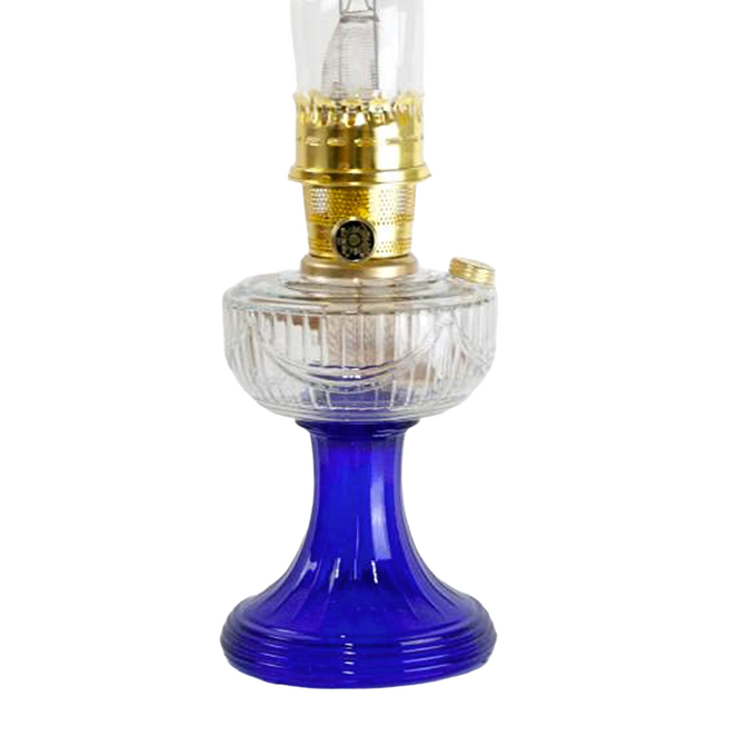 Handcrafted oil lamp featuring a clear glass font with a sweeping design and vibrant cobalt blue base, accented with brass burner, perfect for Lamps & Lighting, Oil Lamps, Table Lamps, Best Sellers, and Promo Eligible collections.