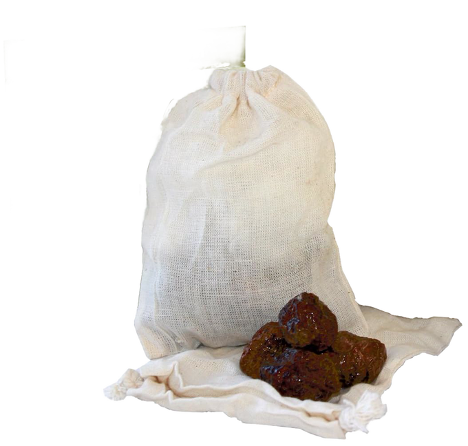 Natural cotton drawstring bag holding handcrafted soap nuts alongside several whole soap nuts, ideal for eco-friendly laundry supplies in Home & Decor and Soaps and Soapmaking collections.
