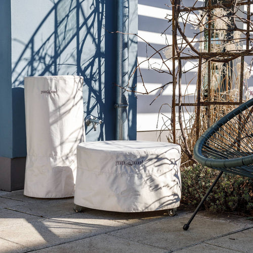 Beige weather-resistant ripstop fabric storage covers with full-length zippers and adjustable fasteners, designed to protect outdoor fire barrels, ideal for Farm, Garden & Tool and Camping collections.
