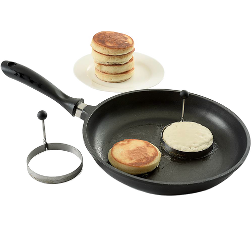 Two handcrafted pancake cooking rings with stay-cool handles used in a black frying pan to make round pancakes, accompanied by a stack of golden cooked pancakes on a white plate, ideal for Kitchen & Food, Kitchen Gadgets, Cooking and Baking Helpers, Best Sellers, and Promo Eligible collections.