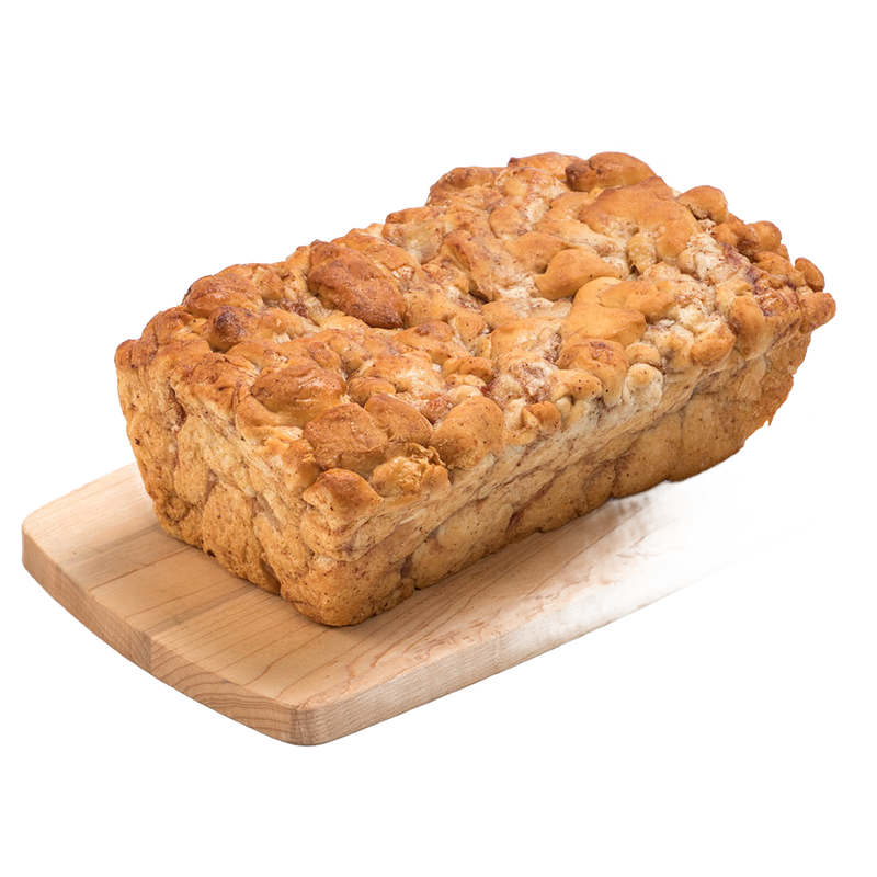 Handcrafted loaf of fresh apple fritter bread with cinnamon and chopped apples, resting on a wooden cutting board, featured in Kitchen & Food, Snacks and Sweets, and USA Made collections.