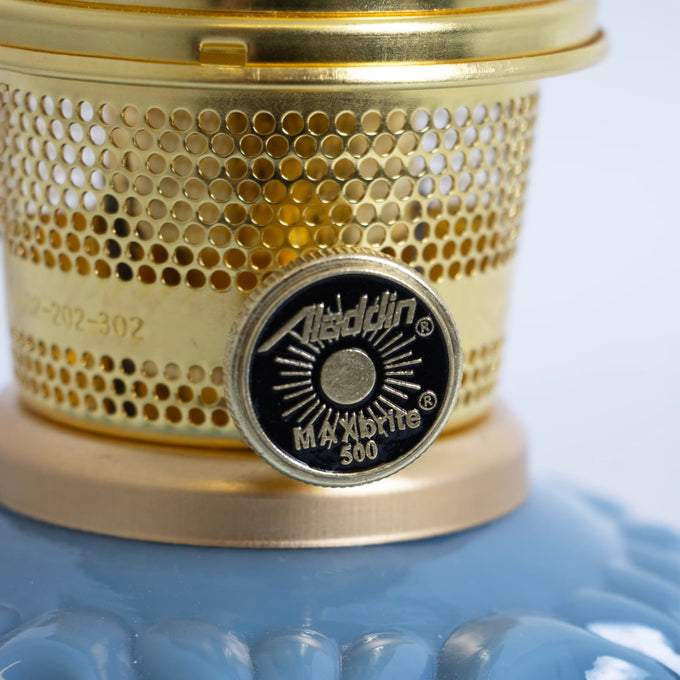 Close-up of a unique handcrafted brass burner with perforated design and distinctive control knob on a Georgia Blue glass base, perfect for Lamps & Lighting, Oil Lamps, Table Lamps, Best Sellers, and Promo Eligible collections.