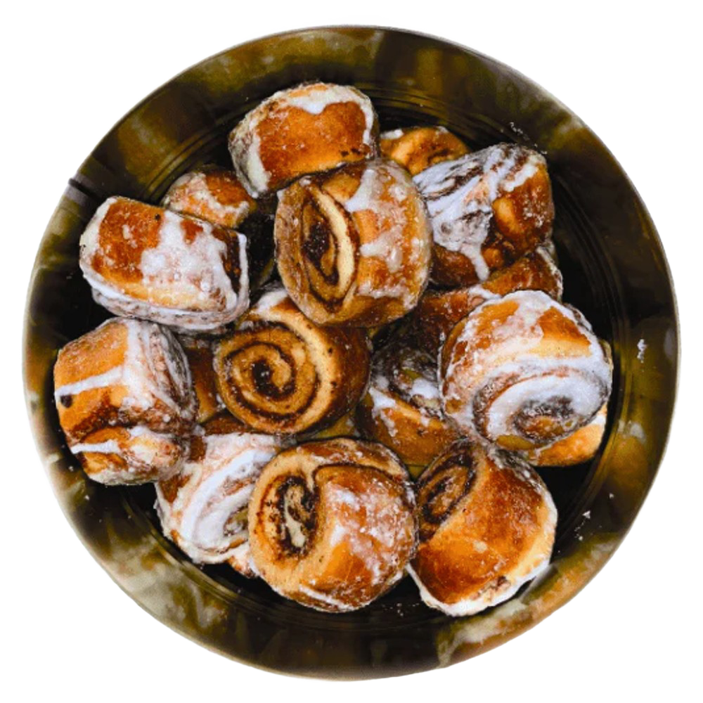 Top view of freeze-dried cinnamon rolls with visible swirls and glaze inside a metal container, crafted in the USA and featured in Kitchen & Food and Emergency Supplies collections.