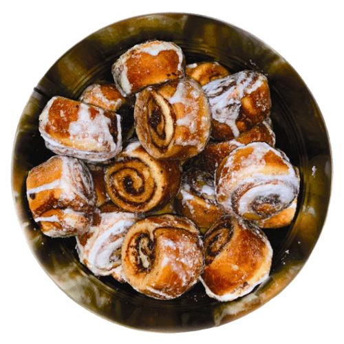 Top view of freeze-dried cinnamon rolls with visible swirls and glaze inside a metal container, crafted in the USA and featured in Kitchen & Food and Emergency Supplies collections.
