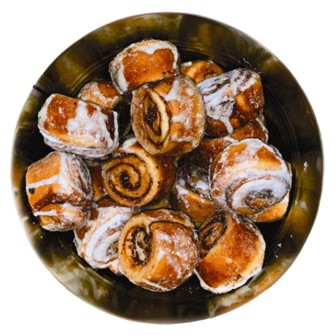 Top view of freeze-dried cinnamon rolls with visible swirls and glaze inside a metal container, crafted in the USA and featured in Kitchen & Food and Emergency Supplies collections.