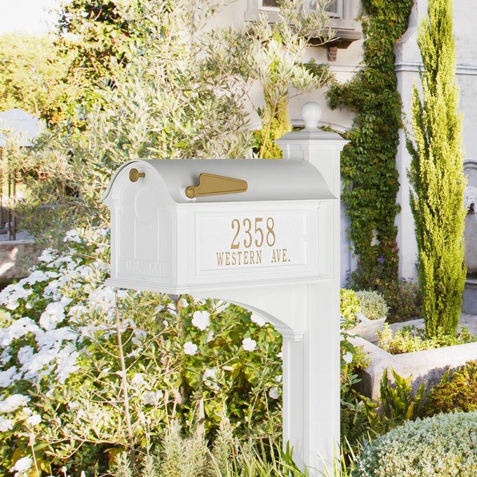 Elegant white and gold handcrafted mailbox with custom address plaque and matching post, made in USA, showcased in a lush garden setting for Home & Decor and Mailboxes and Address Signs collections.