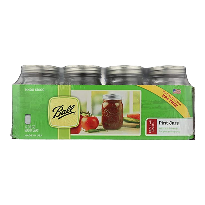 Case of twelve clear glass pint-sized canning jars with silver metal lids and bands, packaged with images of fresh tomatoes and preserves, suitable for Kitchen & Food, Food Preservation, Canning, USA Made, Best Sellers, and Promo Eligible collections.