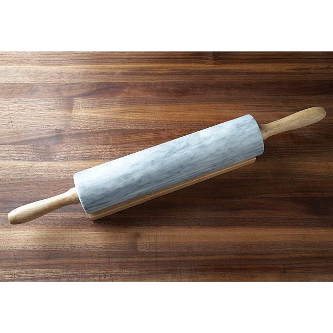 Marble rolling pin with wooden handles resting on wooden stand on a butcher block countertop, featured in Kitchen & Food, Cookware, Baking Supplies, and Best Sellers collections.