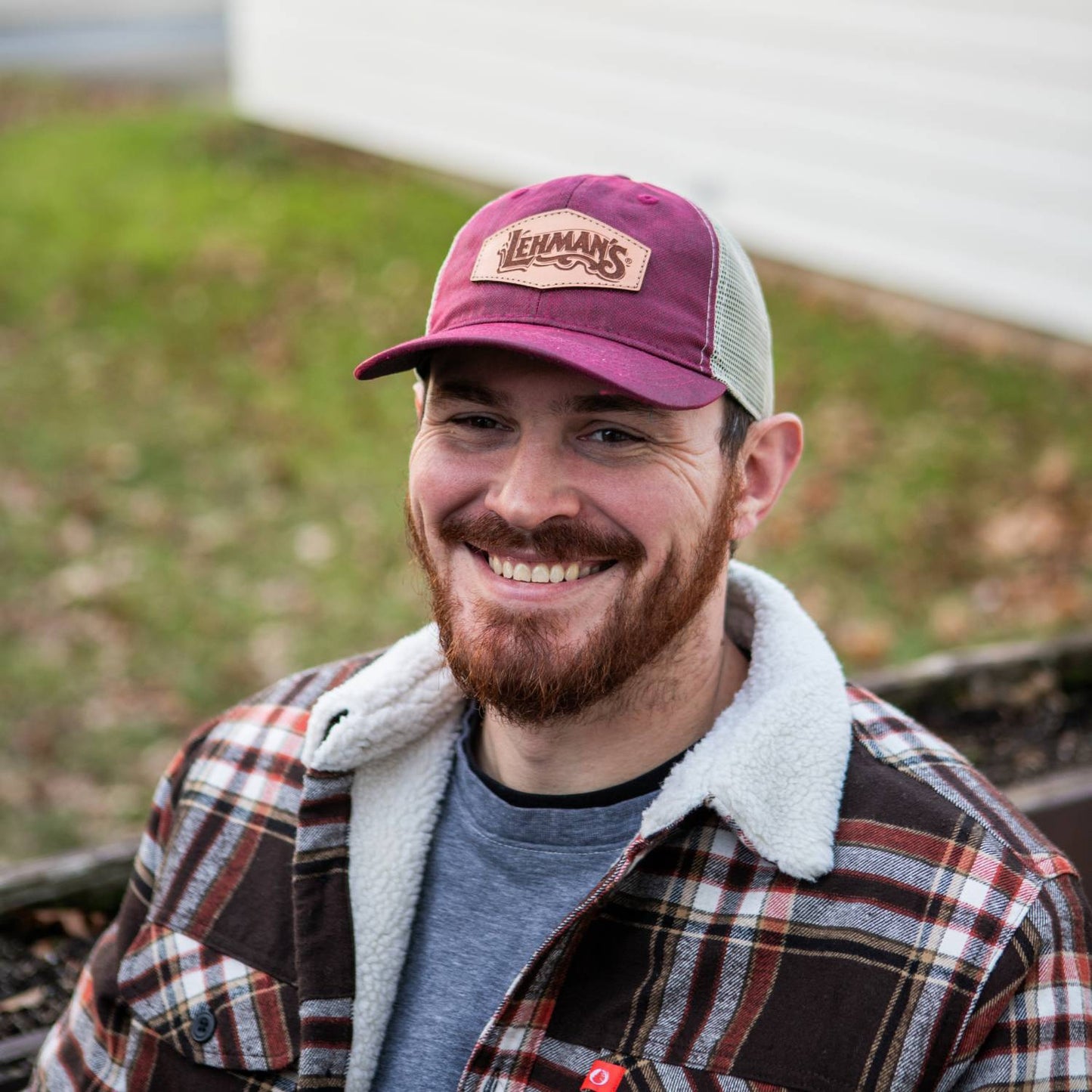 Man wearing a handcrafted adjustable hat with a weathered burgundy cotton front, beige mesh back, and Lehman's leather patch, featured in Health & Wellness, Clothing and Accessories, Best Sellers, and Promo Eligible collections.