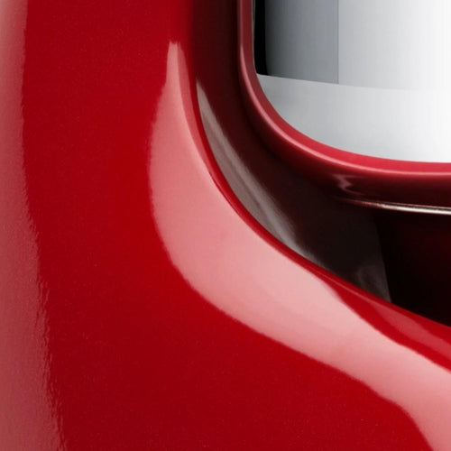 Close-up of a glossy red stand mixer base with a stainless steel bowl edge, showcasing the handcrafted design for Kitchen & Food, Baking Supplies, and Cooking and Baking Helpers collections.