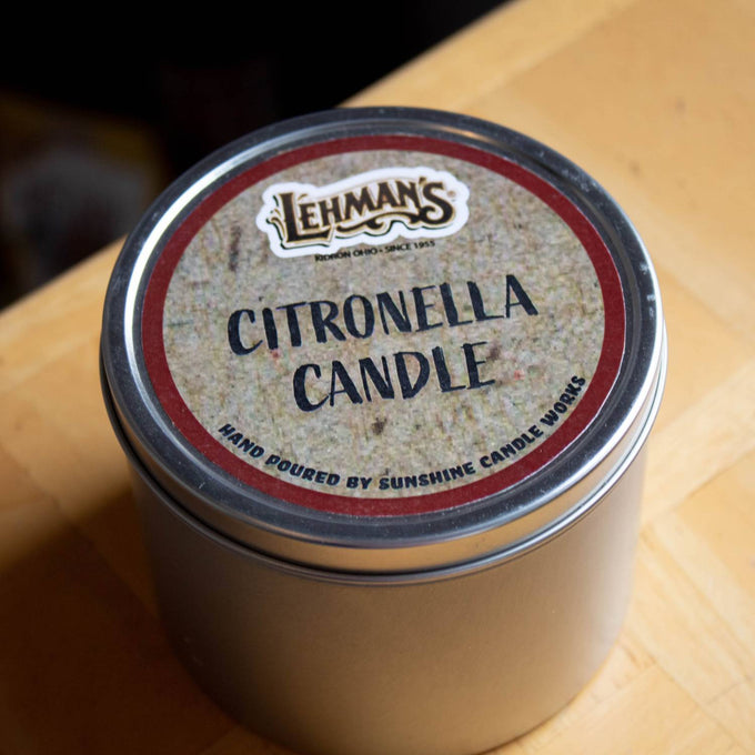 Handcrafted citronella candle in a compact metal tin with a rustic label, ideal for pest control, camping, and outdoor lighting in farm, garden, and tool collections.