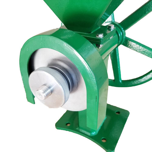 Close-up of the individually machined stainless steel grinding burrs housed in a sturdy green frame with a secure mounting base, designed for hand-cranked grain milling in farm, kitchen, and emergency supplies.