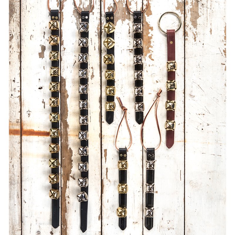 Assortment of handcrafted sleigh bell door hangers featuring brass and silver bells on black and brown leather straps with leather ties, ideal for holiday decor, USA Made, and best sellers in Home & Decor.