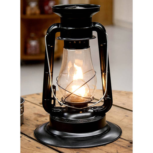 Handcrafted black powder-coated steel lantern with glass chimney and lit wick, designed for dependable light and warmth in Farm, Garden & Tool, Camping, and Emergency Supplies collections.