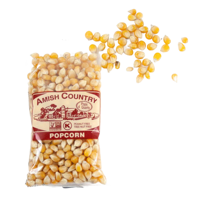 Clear bag of handcrafted Amish Country yellow popcorn kernels spilling onto a white background, featured in Kitchen & Food, Snacks and Sweets, Popcorn, and USA Made collections.