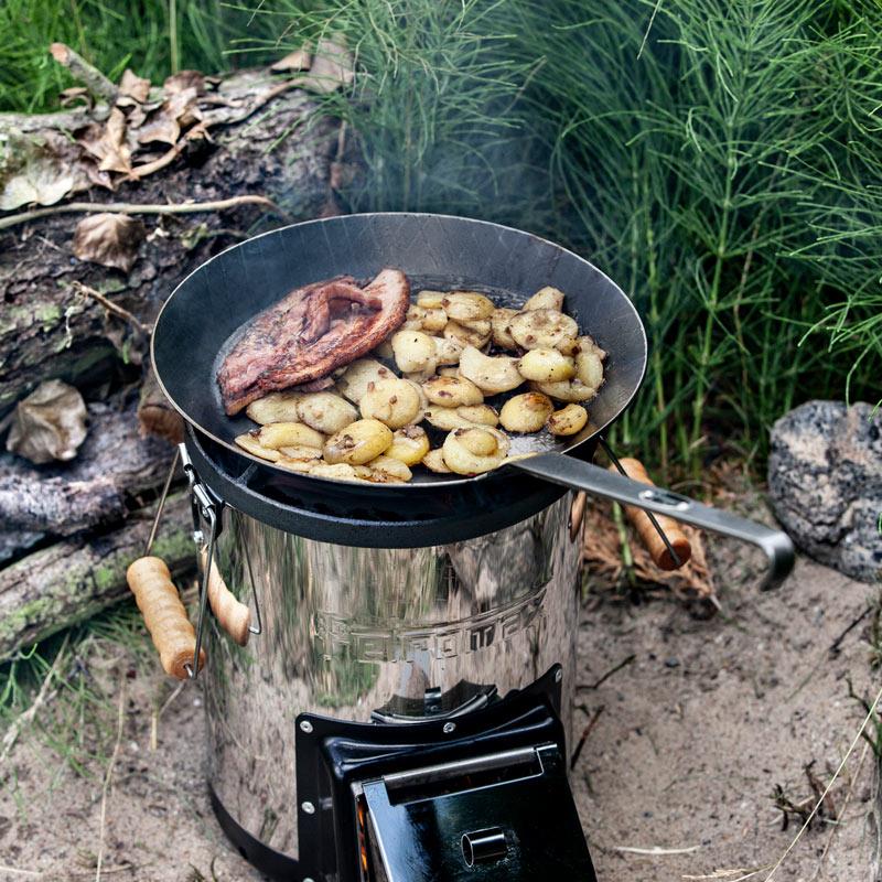 Wrought iron pan with long handle cooking seasoned potatoes and steak over a portable stove outdoors, ideal for Farm, Garden & Tool, Kitchen & Food, Camping, Cookware, Pots and Pans, Best Sellers, and Promo Eligible collections.