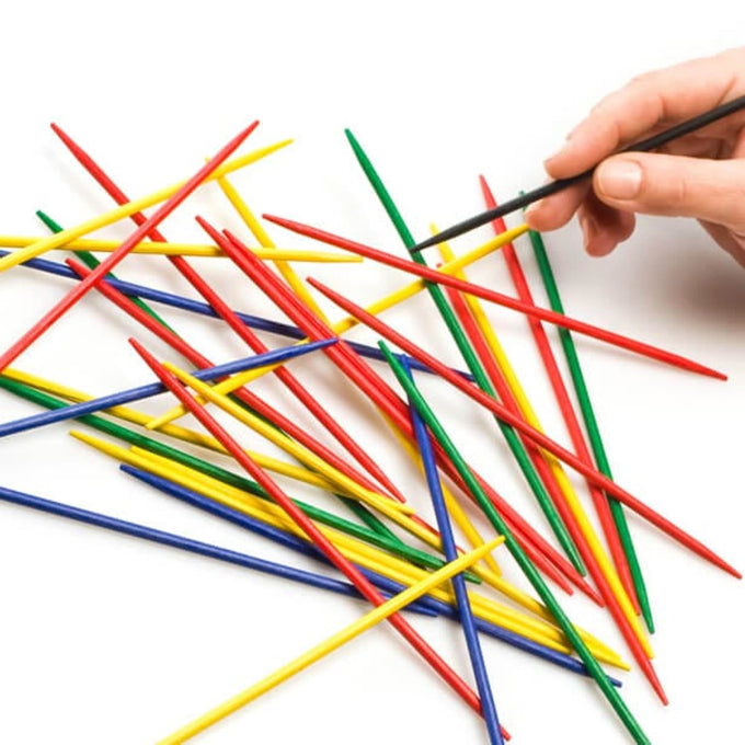 Handcrafted colorful wooden sticks scattered on white background with a hand carefully removing one, ideal for family game nights in Toys, Books & Games, Children's Toys, and Best Sellers collections.