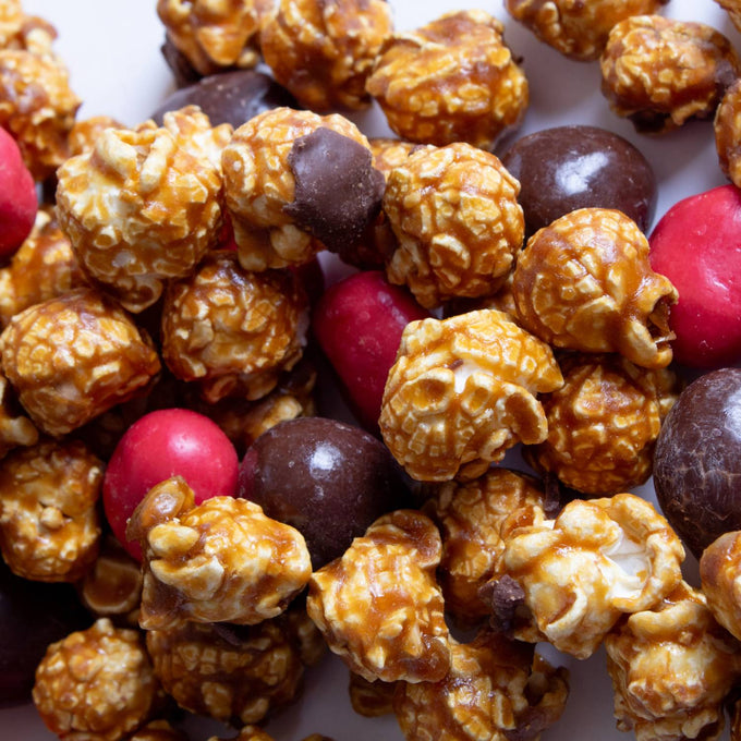 Close-up of handcrafted caramel popcorn mix with festive red and brown chocolate-covered treats, featured in Kitchen & Food, Snacks and Sweets, Popcorn, and Best Sellers collections.