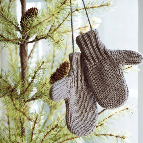 Pair of gray cotton blend mittens hanging on a pine tree branch, adding a cozy touch to holiday decor, featured in Home & Decor and Holiday Decor collections.