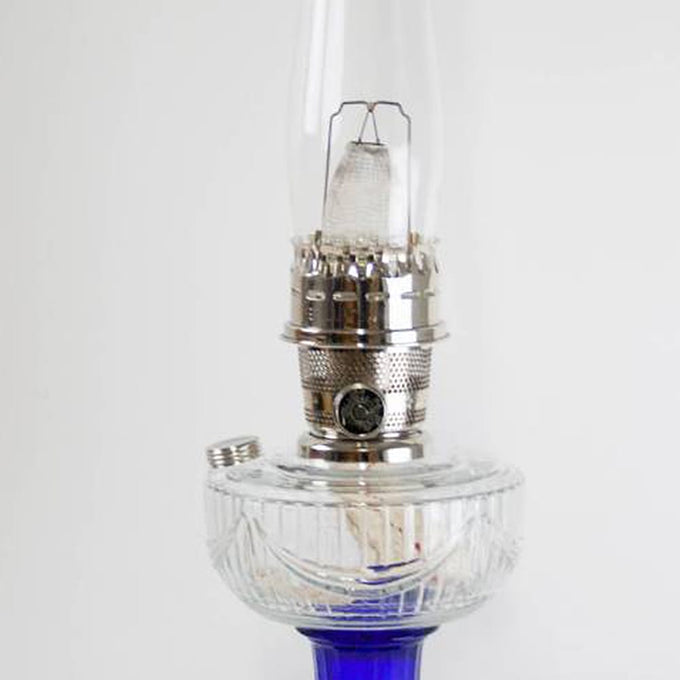 Handcrafted oil lamp featuring a clear glass font with silver nickel burner and vibrant cobalt blue base, blending vintage charm with modern use in Lamps & Lighting, Oil Lamps, Table Lamps, Best Sellers, and Promo Eligible collections.