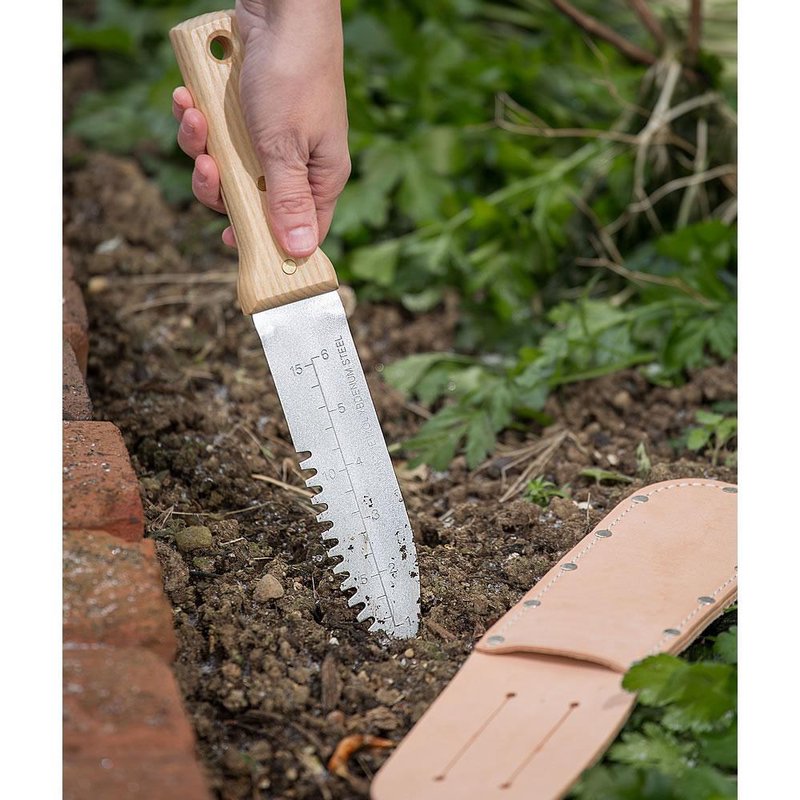 Handcrafted gardening knife with wooden handle and serrated blade marked with measurements, used for digging and cultivating soil in Farm, Garden & Tool, Best Sellers, and Promo Eligible collections.