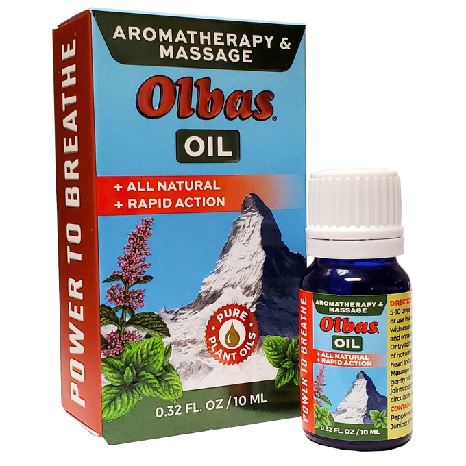 Small blue glass bottle of Olbas aromatherapy and massage oil with white cap next to colorful box featuring mountain and herbal illustrations, labeled all natural and rapid action, part of Health & Wellness and Health Remedies collections.