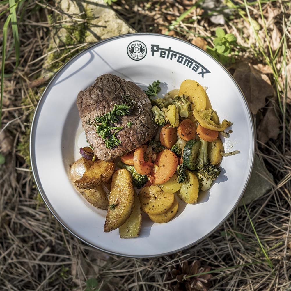 White enamel camping plate with black rim and Petromax logo, holding grilled steak, seasoned vegetables, and potato wedges, designed for Farm, Garden & Tool, Kitchen & Food, Camping, Dinnerware, Best Sellers, and Promo Eligible collections.
