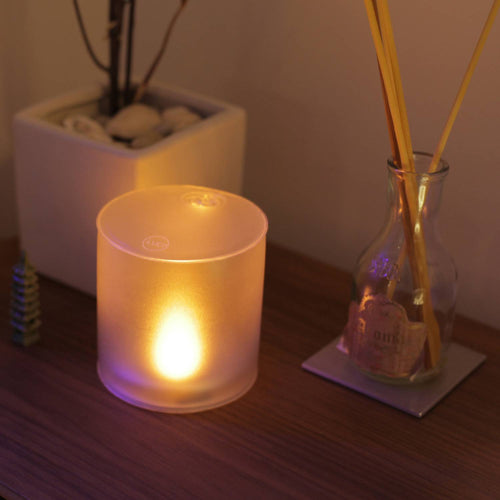 Soft glowing Luci Solar Candle with warm flickering light, designed for safe, flameless ambiance in indoor settings, featured in Lamps & Lighting and Candles collections.