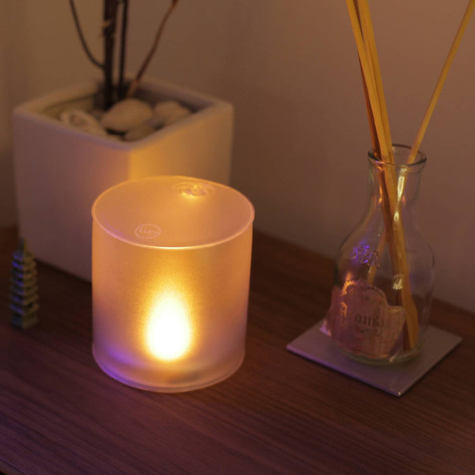 Soft glowing Luci Solar Candle with warm flickering light, designed for safe, flameless ambiance in indoor settings, featured in Lamps & Lighting and Candles collections.