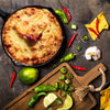 Hot baked cheesy dip in an 8-inch cast iron skillet surrounded by fresh jalapeños, chili peppers, garlic, lime wedges, and tortilla chips, featured in Kitchen & Food, Food, Dry Goods and Mixes, Best Sellers, Promo Eligible collections.
