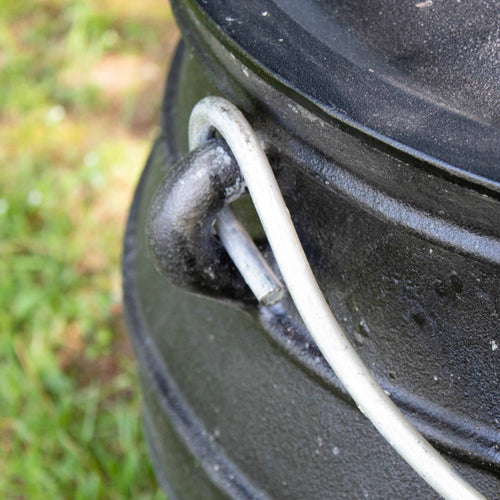 Close-up of a handcrafted cast iron campfire kettle’s sturdy handle attachment, showcasing durable construction ideal for Farm, Garden & Tool, Camping, and Best Sellers collections.