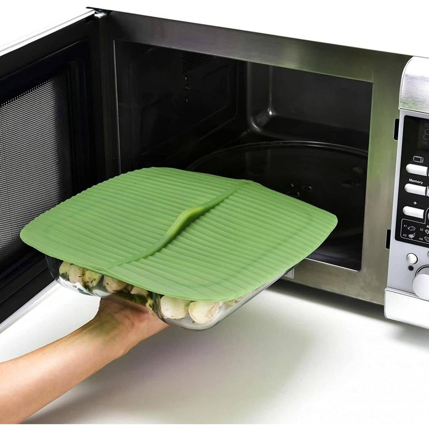 Translucent green reusable silicone bowl cover with a banana leaf design sealing a glass dish of mushrooms, safe for microwave use, ideal for Kitchen & Food, Kitchen Gadgets, and Storage and Serving collections.