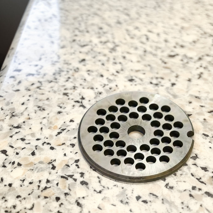 Handcrafted steel chopper plate with a pattern of circular holes, made in USA, ideal for Kitchen & Food, Specialty Equipment, Butchering Supplies, USA Made, Best Sellers, and Promo Eligible collections.