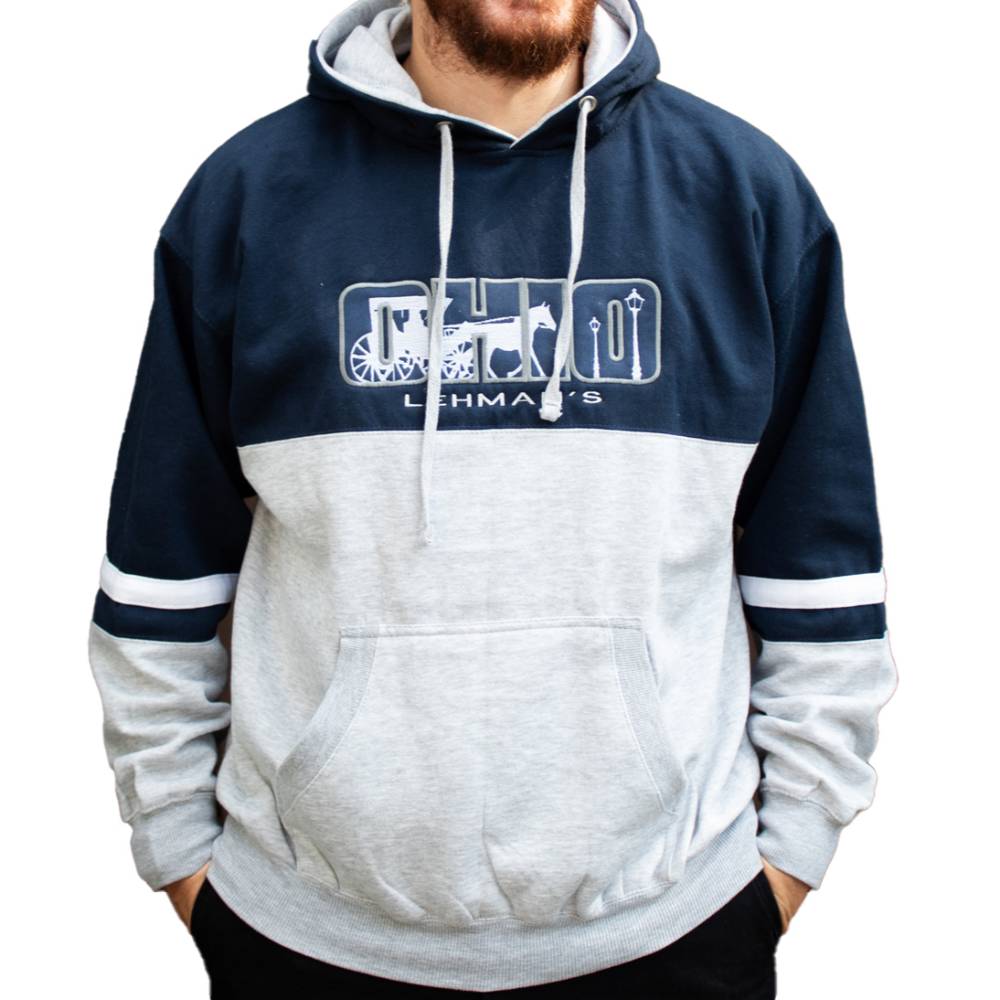 Man modeling a handcrafted fleece hoodie sweatshirt in navy and gray with color blocking, arm stripes, a drawstring hood, front pocket, and embroidered Ohio design, featured in Health & Wellness and Clothing and Accessories collections.