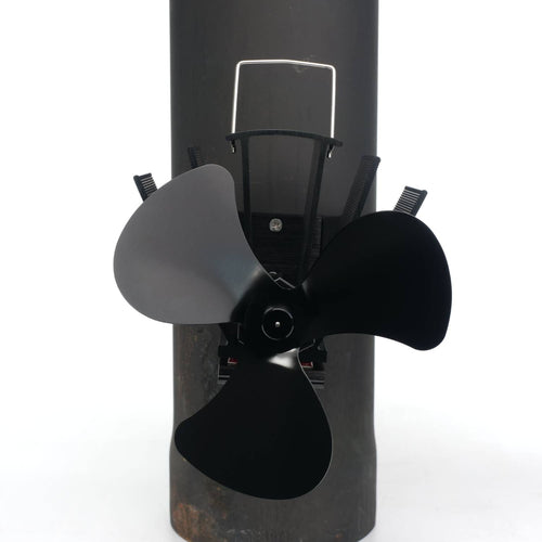 Three-bladed black magnetic fan mounted on a stove flue pipe with metal fins, designed to circulate warm air efficiently in hearths, featured in Stoves, Hearth Accessories, Best Sellers, and Promo Eligible collections.